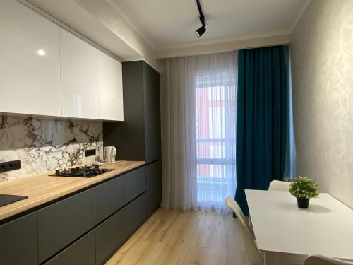 a kitchen with a table and a dining room at New chisinau in Chişinău