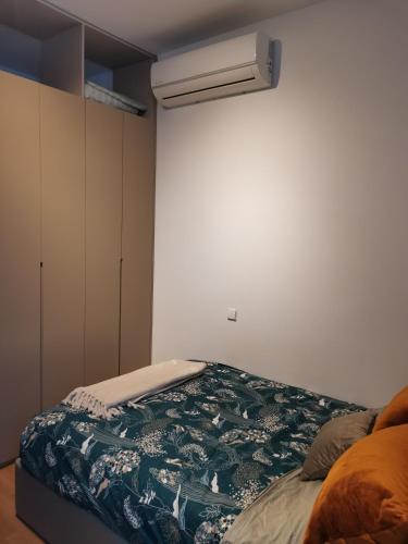 a bedroom with a bed and a air conditioner at Casa da Lara in Aveiro