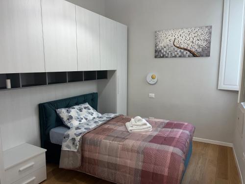 a small bedroom with a bed with a blanket at Appartamento Elena in Parma
