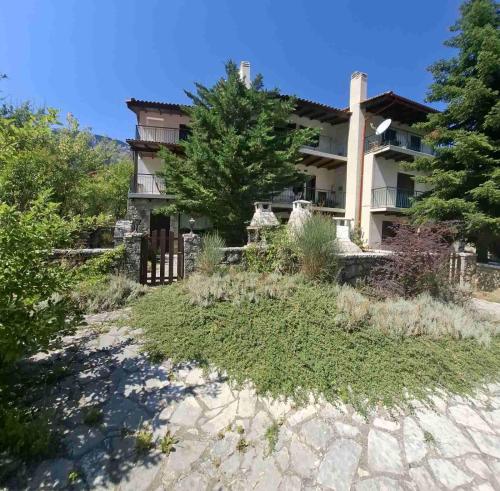 a house on a hill with a yard with grass at Horizon Nest Parnassos Villa Chalet! in Eptalofos