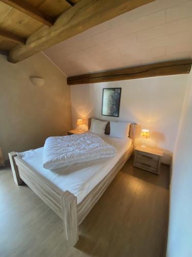 a bedroom with a bed with two lamps on it at Maboge 20C in La Roche-en-Ardenne
