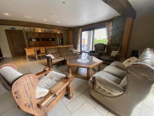 a living room with couches and chairs and a table at Maboge 20C in La Roche-en-Ardenne