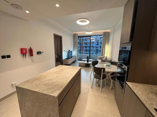 a kitchen with a table and a dining room at Amazing Dubai Silicon Oasis Rental Apartments in Dubai