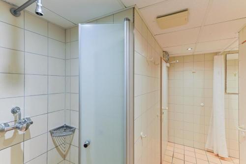 a shower with a glass door in a bathroom at Appartment Sünnschien in Kronsgaard