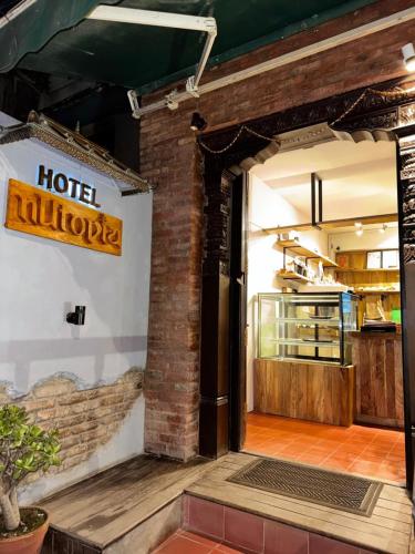 an open door to a restaurant with a hotelulum sign at Hotel Nutopia in Pātan