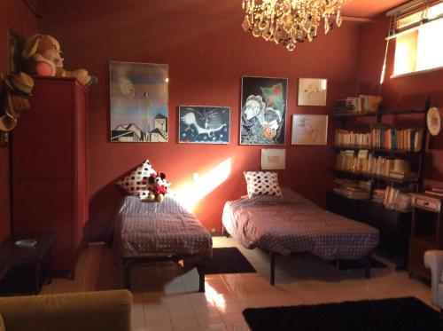 a living room with two stools and a chandelier at Villa Nanda a 15 minuti da Roma piscina esclusiva , villa nella natura in Formello