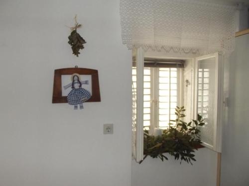 a room with a window and a picture on the wall at Studio In Einem Traditionellen Steinhaus, In Baska in Baška