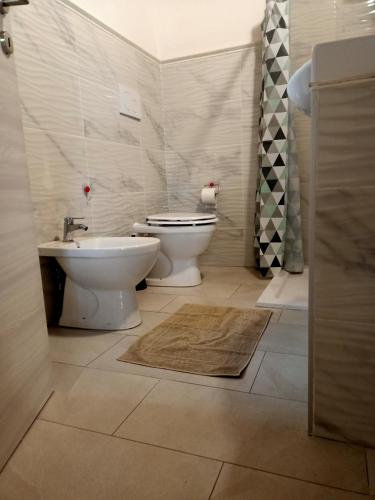 a bathroom with a toilet and a sink at Le coste sul lago in Montefiascone