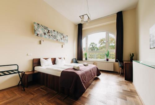 a bedroom with a bed and a large window at SasOne & Sas Two & Sas HO in Budapest