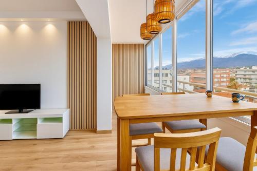 a dining room with a table and a television at SANTA BEACH in Roses
