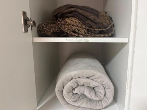 a towel and other towels in a closet at Gold Flat Cabo Branco in João Pessoa