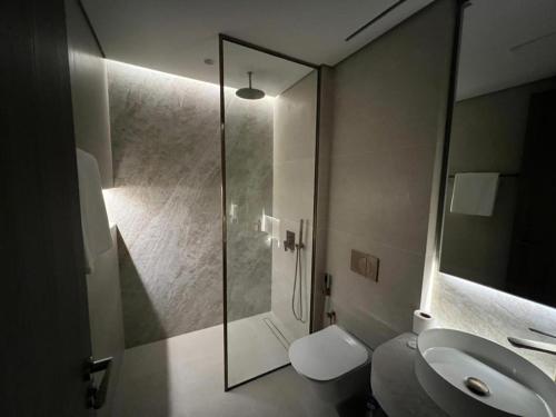 a bathroom with a shower and a toilet and a sink at Amazing Dubai Silicon Oasis Rental Apartments in Dubai