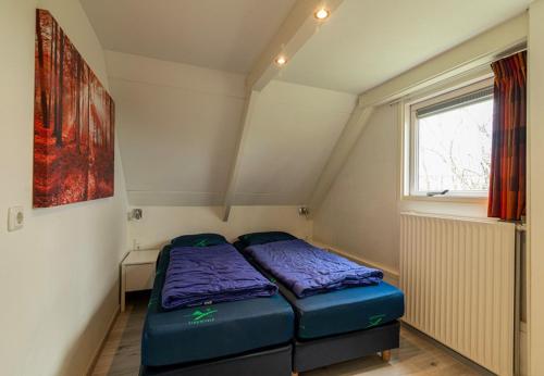 a small room with two beds in it at Bungalowpark Simpelveld - Alpha 97 in Simpelveld