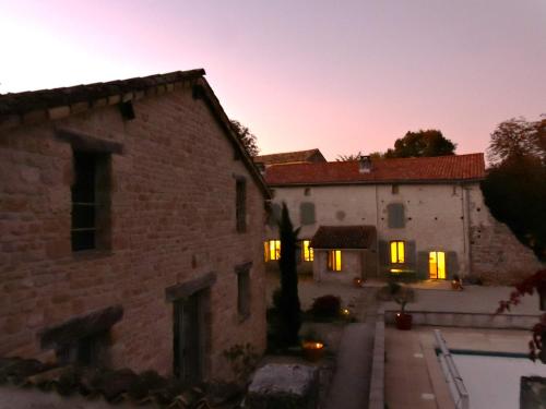 a view of a building at sunset at Charente Cozy Family Winter Retreat in Theil-Rabier