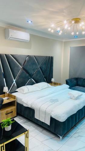 a bedroom with a large bed and a couch at Crown Palace Guesthouse in Pretoria
