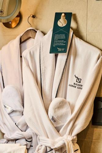 a towel hanging on a wall with a tag on it at Balder Luxury Lodge & Glass Igloos in Levi