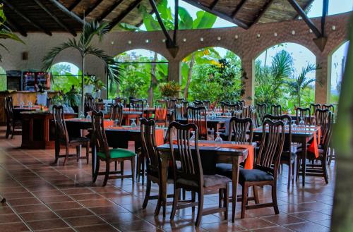 un comedor con mesas y sillas en un restaurante en Hotel Mountain Paradise, en Fortuna