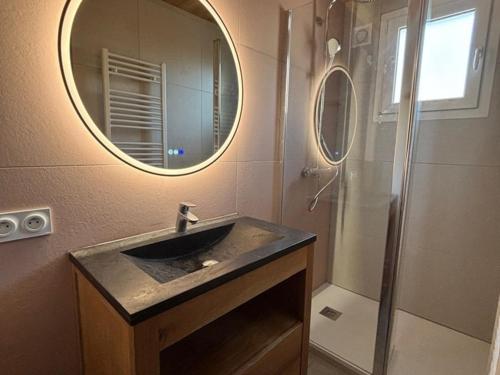 a bathroom with a sink and a mirror and a shower at Appartement 2 pièces, 4 pers, balcon, parking, sauna - FR-1-263-87 in Valloire