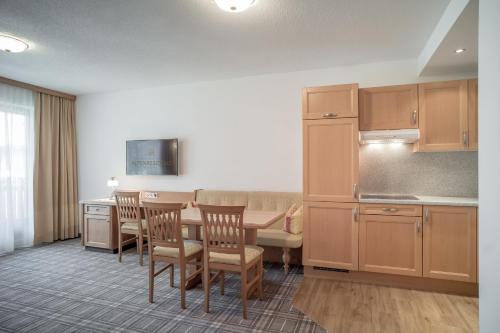 a kitchen with a table and chairs in a room at Alpenresidenz am Mühlbach in Obergurgl