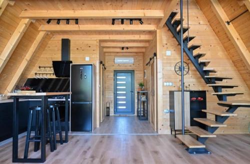 a large kitchen with a staircase in a log cabin at 2 Bedroom Holiday Home in Topusko