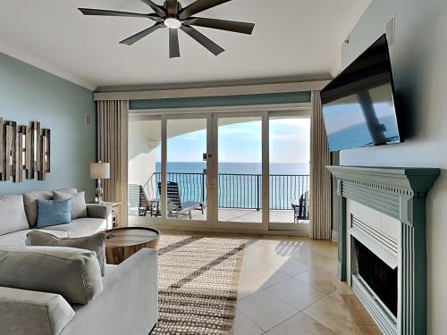 a living room with a fireplace and a tv at Adagio #203A in Santa Rosa Beach