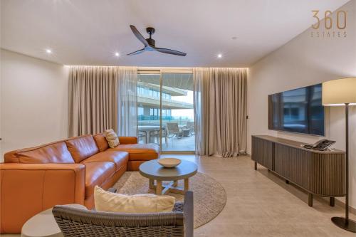 a living room with a couch and a tv at The Rabat Viewpoint Suites by 360 Estates in Ħal-Bajjada