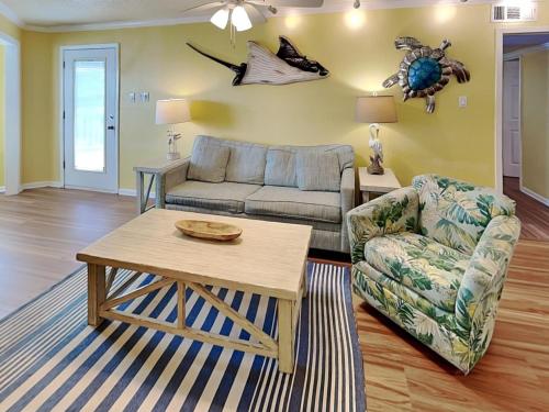 a living room with a couch and a table at Seaside Delight in Mustang Beach