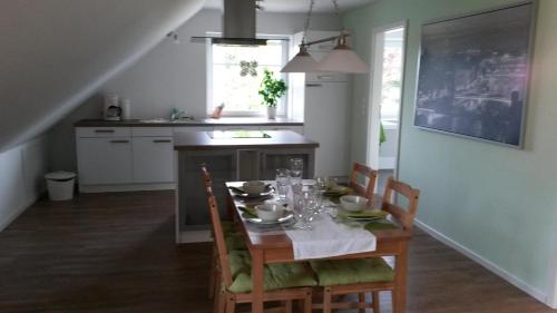 a kitchen with a table with chairs and a tableablish at Lütt Gammelby in Gammelby