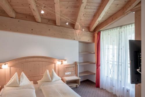 Un pat sau paturi într-o cameră la Alpenresidenz am Mühlbach