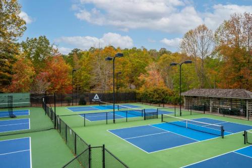 a group of tennis courts with trees in the background at Whispering Knoll - Jasper, GA - Enjoy Peaceful Forest Views, Settle in for Movie Night in the Private Theater Room, Stay Active in Jasper