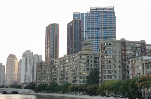 a city skyline with tall buildings and a river at Shanghai Zighouse--The Bund Premium Apartment Suites in Shanghai