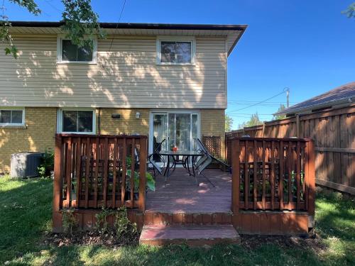 a backyard with a wooden deck with a table at Rm2 - Bright and Gorgeous in Mississauga
