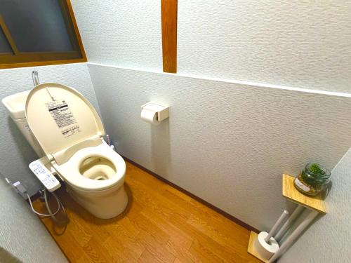 a bathroom with a toilet with the lid up at MM HOUSE Near Takamatsu Station 徒歩3分無料駐車場1台有り in Takamatsu