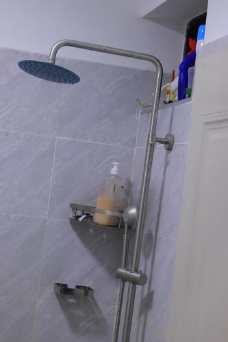 a glass shower door with an umbrella and sunglasses at Quick Connect Studio Kileleshwa in Nairobi