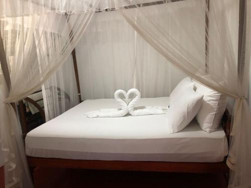 Ένα ή περισσότερα κρεβάτια σε δωμάτιο στο Secret Garden Mirissa