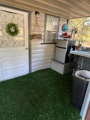 a kitchen with a green carpeted floor in a house at Neals Nest Cozy Cabin in Chiefland