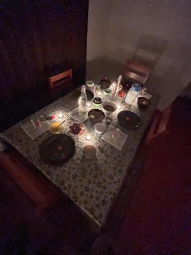 a table with plates and candles on top of it at Casa eka in Ooty
