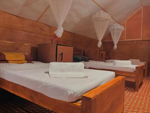 a room with two beds in a tent at Elephant point tree house in Sigiriya