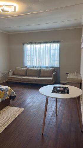 a living room with a couch and a table at Seaside Studio 22 in East London