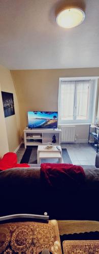 a living room with a couch and a bed at Le Mahanaim House in Nevers