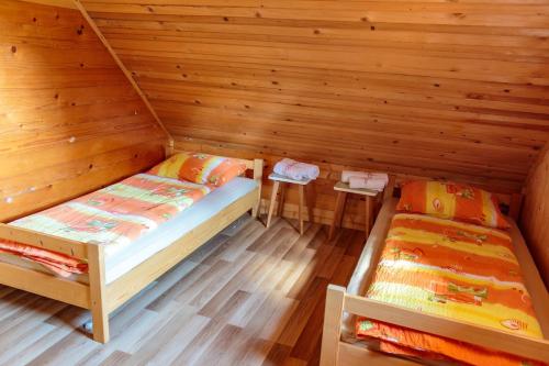 a room with two beds in a cabin at Mountain lodge Pokljuka in Bohinjska Bistrica