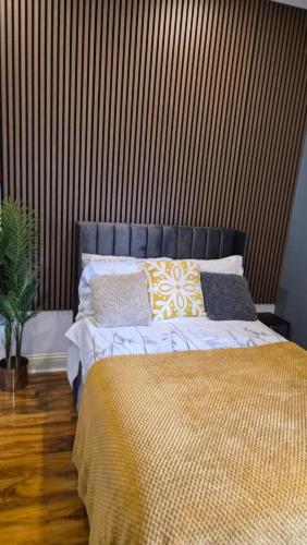 a bedroom with a large bed with pillows on it at Dodi Aparts London, near Stratford close to tube station in London