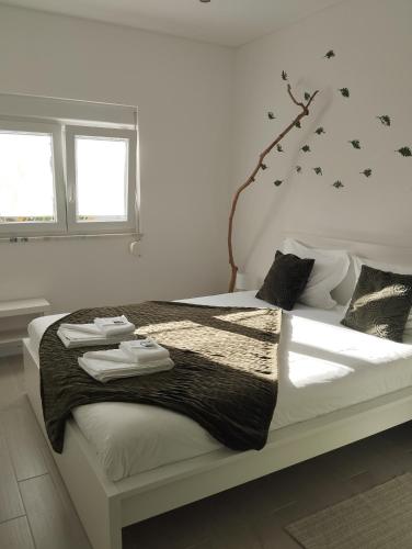 a bedroom with a bed with black stars on the wall at Eira da Mila in Coimbra