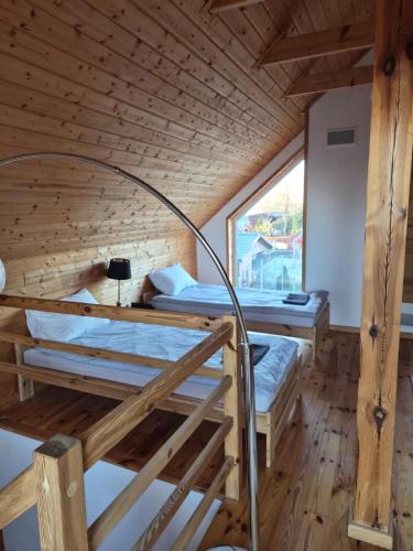a room with two bunk beds in a cabin at Pensjonat Paskudy in Paskudy