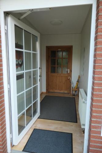 an entrance to a house with the door open at Ferienhaus in der Trift in Winsen
