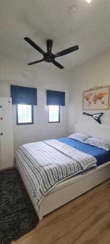 une chambre avec un lit avec un ventilateur de plafond dans l'établissement H&H Bangi Sentral Suites, à Bangi