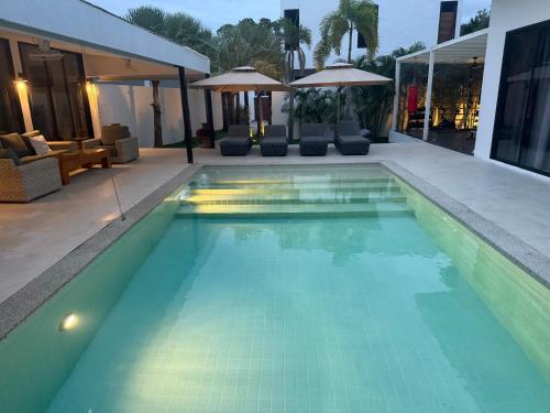a swimming pool in a house at Beautiful private 3 bedroom villa with pool and gym in Rawai Beach