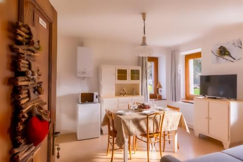 a kitchen and dining room with a table and chairs at Garden Dream in Valle di Cadore