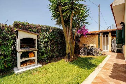 un petit four dans l'herbe à côté d'une maison dans l'établissement Villa Leo, à Terracine