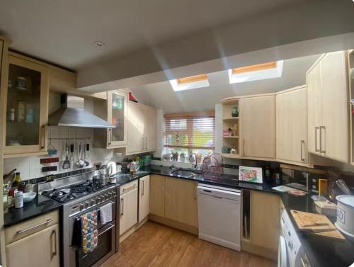 a kitchen with white appliances and wooden cabinets at Number 42 in Woodstock